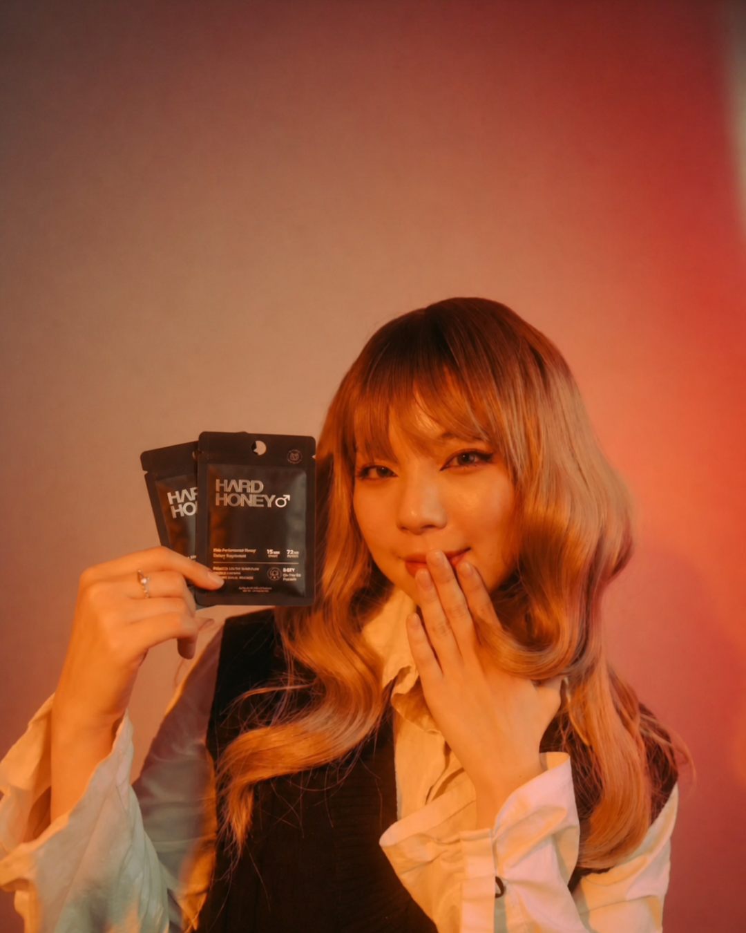 Woman holding Hard Honey pouches