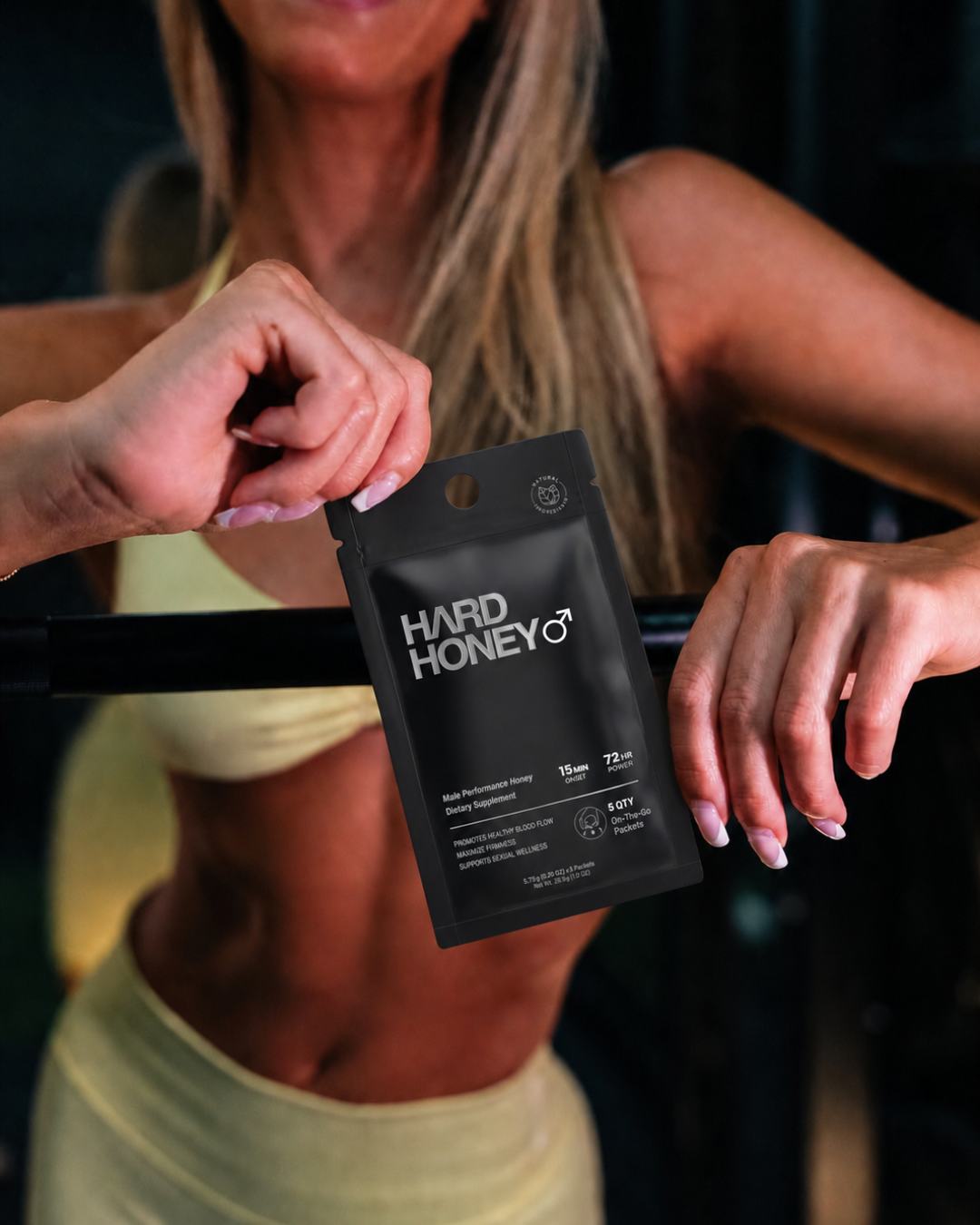 Woman presenting the Hard Honey pouch